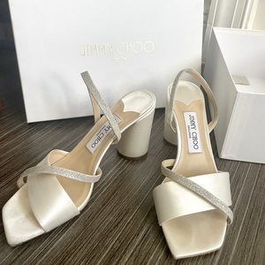 Jimmy Choo block heel sandals in ivory/platinum ice with satin/dusty glitter.